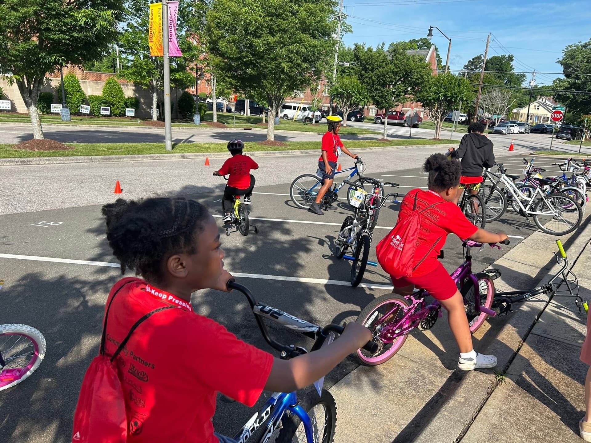 Youth riding bikes through Henderson during the AIMHigh bike safety event