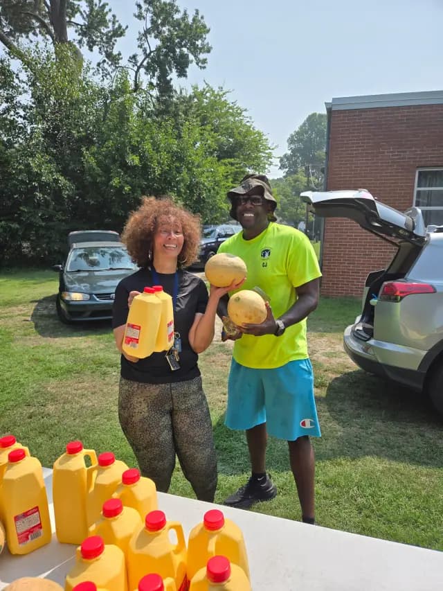 CJ distributing food and produce at a community event
