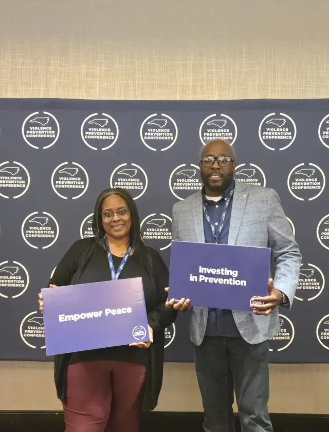 CJ Turrentine at NC Violence Prevention Conference with Empower Peace sign